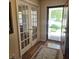 View of the foyer featuring French doors, a wooden floor, an exterior door, and a decorative rug at 7608 Mather Ln, Indianapolis, IN 46239