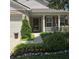 Inviting front porch with decorative shutters and a landscaped garden adding to the curb appeal at 7608 Mather Ln, Indianapolis, IN 46239