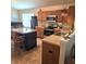 Functional kitchen with oak cabinets, updated appliances, and a convenient kitchen island at 7608 Mather Ln, Indianapolis, IN 46239