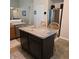 Kitchen island with seating, stainless steel appliances, and ample storage space at 7608 Mather Ln, Indianapolis, IN 46239