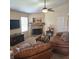 Cozy living room with a traditional fireplace and plush leather seating at 7608 Mather Ln, Indianapolis, IN 46239