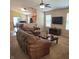 The living room features a ceiling fan, a leather sofa, and transitions into the dining area at 7608 Mather Ln, Indianapolis, IN 46239