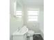 Clean bathroom with white fixtures, tile walls, and modern flooring at 8210 Patton Dr, Lawrence, IN 46226