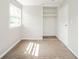 This carpeted bedroom boasts a closet and ample natural light at 8210 Patton Dr, Lawrence, IN 46226