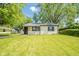 Well-maintained single-story home featuring a cozy front entrance and a lush green lawn at 8210 Patton Dr, Lawrence, IN 46226