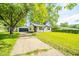 Charming single-story home with a detached garage, a well-maintained lawn and mature shade trees at 8210 Patton Dr, Lawrence, IN 46226