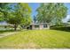 Inviting single-story house with a well-kept lawn, mature trees, and an attractive exterior at 8210 Patton Dr, Lawrence, IN 46226
