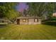 Charming single-story home with a well-maintained lawn and mature trees at 8210 Patton Dr, Lawrence, IN 46226