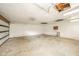 This empty garage has a damaged ceiling and concrete floor at 8210 Patton Dr, Lawrence, IN 46226