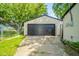 A detached garage with a dark garage door at 8210 Patton Dr, Lawrence, IN 46226