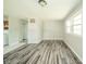 Bright living room with neutral walls, wood-look floors, and ample natural light at 8210 Patton Dr, Lawrence, IN 46226