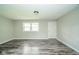 Minimalist living room showcasing new floors, neutral decor, and natural light from windows at 8210 Patton Dr, Lawrence, IN 46226