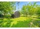 Image of a storage shed surrounded by lush greenery at 8210 Patton Dr, Lawrence, IN 46226