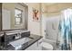 Bathroom with a framed mirror, neutral walls, and a combined shower and bathtub with a floral shower curtain at 830 Freeland Way, Carmel, IN 46032