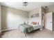 Bedroom with neutral carpet, a comfortable bed with patterned bedding and bright lighting at 830 Freeland Way, Carmel, IN 46032
