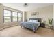 Bright bedroom with large windows, a comfortable bed with patterned bedding, and neutral carpet at 830 Freeland Way, Carmel, IN 46032
