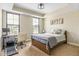 Bedroom with a desk and chair, neutral carpet, a comfortable bed with patterned bedding at 830 Freeland Way, Carmel, IN 46032