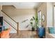 Open entryway with wooden staircase, hardwood floors, and a plant, creating a welcoming atmosphere at 830 Freeland Way, Carmel, IN 46032