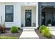 The front entrance features a black door, fresh landscaping, and a concrete walkway at 830 Freeland Way, Carmel, IN 46032