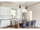 Stylish kitchen features white cabinets, stainless steel appliances, and an island with a breakfast bar at 830 Freeland Way, Carmel, IN 46032