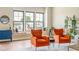 Bright living room featuring two chairs, large windows, and hardwood floors at 830 Freeland Way, Carmel, IN 46032
