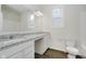 Well-lit bathroom with granite counters, double sinks, and a large mirror at 8344 Leander Ave, Zionsville, IN 46077