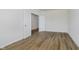 Clean bedroom featuring hardwood floors, white walls, and doors leading to other rooms at 8344 Leander Ave, Zionsville, IN 46077