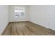 Bright bedroom featuring hardwood floors and a large window, perfect for relaxation at 8344 Leander Ave, Zionsville, IN 46077