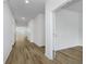 Bright hallway with wood-look flooring, white trim, and doors leading to various rooms at 8344 Leander Ave, Zionsville, IN 46077
