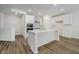 Modern kitchen with a large island, stainless steel appliances, and white cabinetry at 8344 Leander Ave, Zionsville, IN 46077