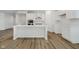 Bright kitchen features a large island, stainless steel appliances, and white cabinets at 8344 Leander Ave, Zionsville, IN 46077