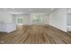 Spacious living area featuring light hardwood floors, large windows, and a kitchen island at 8344 Leander Ave, Zionsville, IN 46077