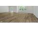 Open-concept living space with wood-look floors, sliding glass doors, and ample natural light at 8344 Leander Ave, Zionsville, IN 46077