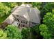 Aerial view showcases the home's large roof, beautiful deck, and well-maintained yard surrounded by trees at 9190 Hastings Trce, Indianapolis, IN 46234