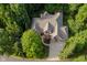 An overhead view of the house featuring a driveway, lush landscaping, a well manicured yard, and mature trees at 9190 Hastings Trce, Indianapolis, IN 46234