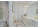 Elegant bathroom with a vanity, shower and striped wallpaper at 9190 Hastings Trce, Indianapolis, IN 46234