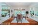 Dining room with hardwood floors, natural light, and views into the living room and sunroom at 9190 Hastings Trce, Indianapolis, IN 46234