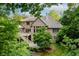 Exterior of this beautiful brick home showing the deck and lush surrounding greenery at 9190 Hastings Trce, Indianapolis, IN 46234