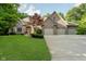 Attractive brick home featuring an attached three car garage and meticulously maintained lawn at 9190 Hastings Trce, Indianapolis, IN 46234