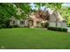 Elegant brick home featuring a well-maintained front yard, complemented by lush landscaping and an attached garage at 9190 Hastings Trce, Indianapolis, IN 46234