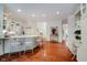 Spacious kitchen featuring hardwood floors, white cabinetry and an island with seating at 9190 Hastings Trce, Indianapolis, IN 46234