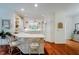 Bright kitchen with white cabinets, hardwood floors, and an island with bar seating at 9190 Hastings Trce, Indianapolis, IN 46234