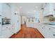 Bright kitchen featuring white cabinetry, hardwood floors, and an open layout at 9190 Hastings Trce, Indianapolis, IN 46234