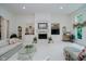 Open concept living room featuring a fireplace, built in shelves, and large window at 9190 Hastings Trce, Indianapolis, IN 46234