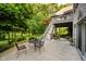 Outdoor patio with seating and stairs leading to an upper deck overlooking the backyard at 9190 Hastings Trce, Indianapolis, IN 46234