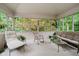 Relaxing screened-in porch featuring cozy seating and peaceful views of trees at 9190 Hastings Trce, Indianapolis, IN 46234