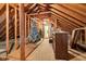 Unfinished attic with exposed rafters, Christmas trees and a built-in cabinet showing storage and potential at 9722 N Gasburg Rd, Mooresville, IN 46158