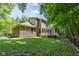 Lush green lawn leads up to a yellow home with a spacious back deck, partially enclosed by wooden fencing at 9722 N Gasburg Rd, Mooresville, IN 46158