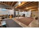 Spacious basement featuring exposed beams, concrete floors, rugs and ample open space for storage or customization at 9722 N Gasburg Rd, Mooresville, IN 46158