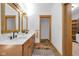 Bright bathroom featuring a double sink vanity with wood cabinets and framed mirrors at 9722 N Gasburg Rd, Mooresville, IN 46158